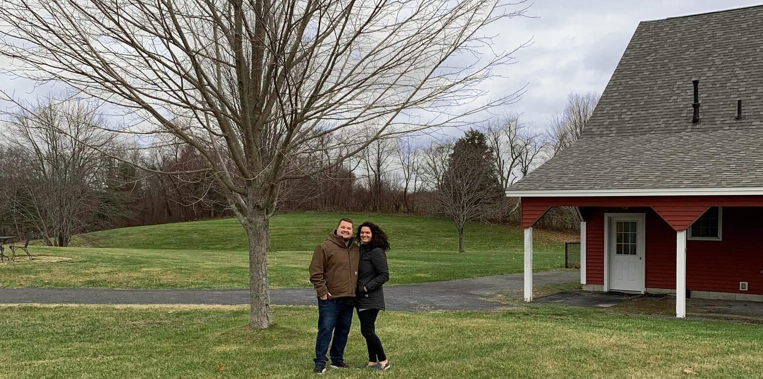 Alicia and husband in front of barn door
