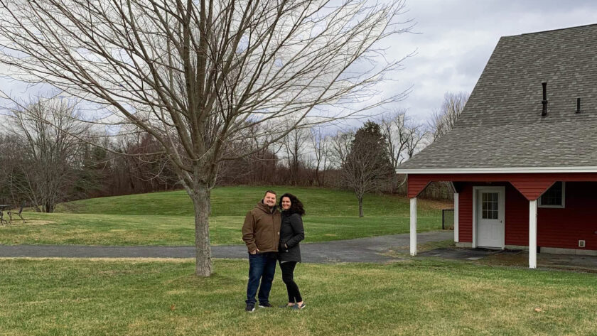 Alicia and husband in front of barn door