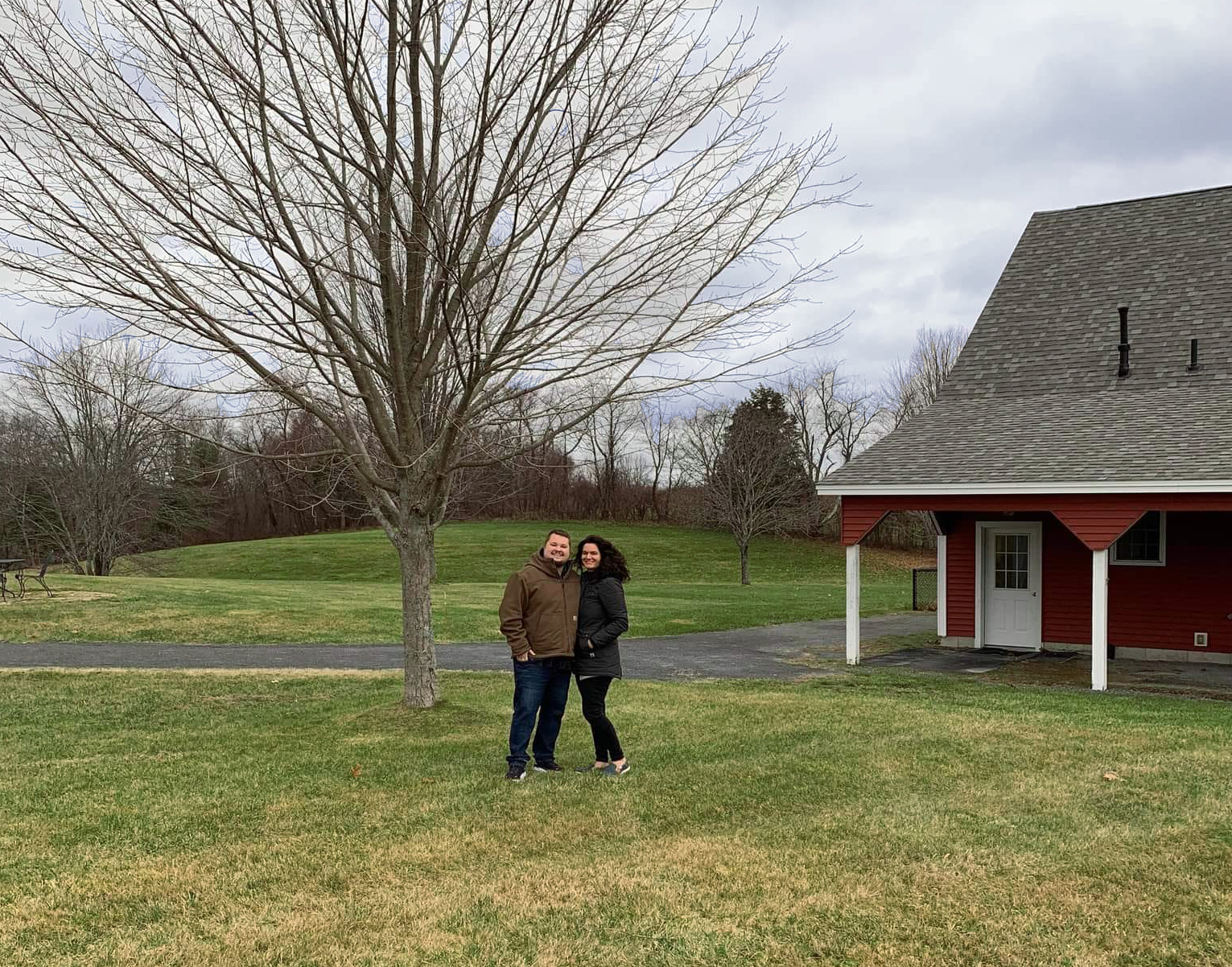 Alicia and husband in front of barn door