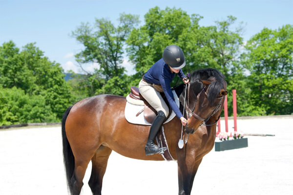 Rider on horse using clicker training.