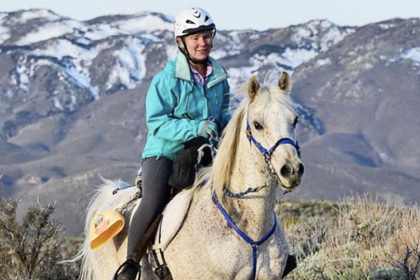 Karen riding her grey Arabian horse, Chief